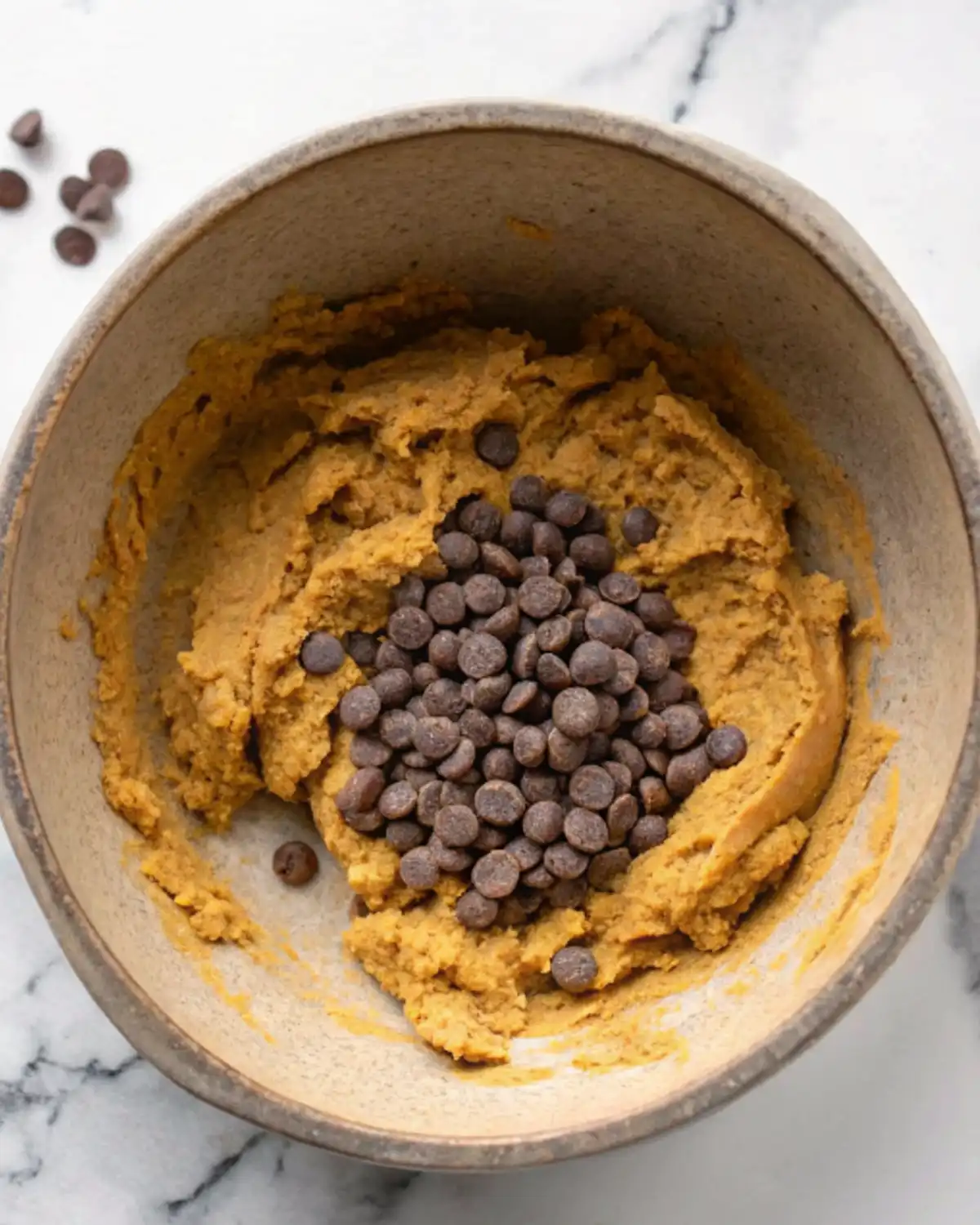 Chocolate chips mixed into cookie dough