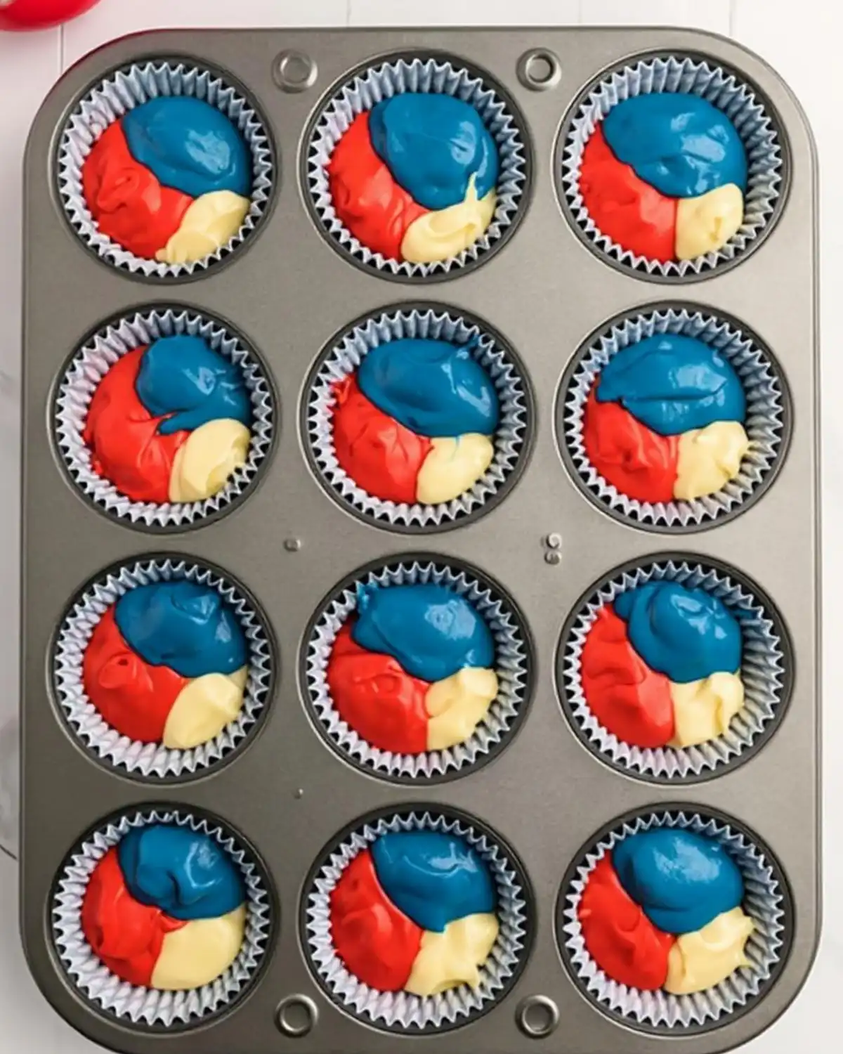 red white blue cupcake batter in liners