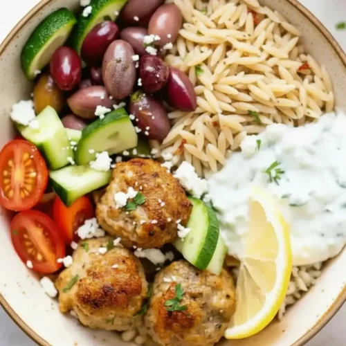 Greek Turkey Meatballs Greek turkey meatballs with orzo, tzatziki sauce in a Mediterranean bowl.